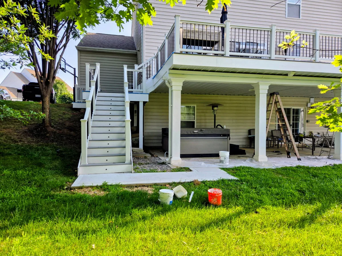 Elevated deck renovation in progress with new stairs, railings, and support columns